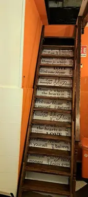 a set of stairs in a room with writing on the wall at Ostello Exclusive Dependance in Palermo