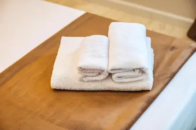 a bedroom with a large bed with towels on it at My Place B&B in Carini