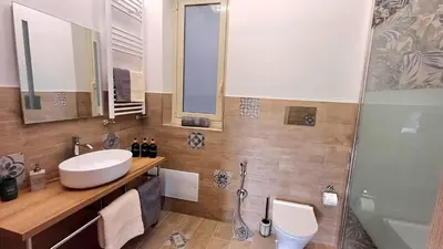 a bathroom with a sink and a shower and a toilet at Palermo case vacanza in Palermo
