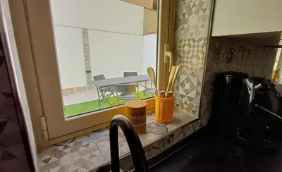 a kitchen with a sink and a window with a table at Palermo case vacanza in Palermo