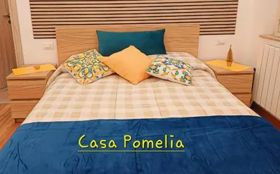 a bedroom with a large bed with blue and yellow pillows at Palermo case vacanza in Palermo