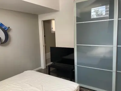 a bedroom with a glass book shelf next to a piano at Casa levante in Palermo