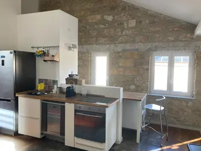 a kitchen with a refrigerator and a table in it at Casa levante in Palermo