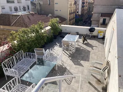 a patio with a table and chairs on a balcony at Casa levante in Palermo