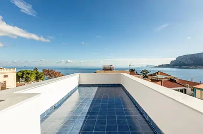 a view of a swimming pool on the roof of a building at GuestHost - Alle Terrazze Blu - Mondello Sea View Apartment in Palermo