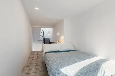 a bedroom with a bed in a white room at GuestHost - Alle Terrazze Blu - Mondello Sea View Apartment in Palermo