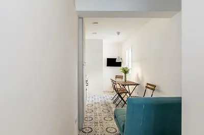 a living room with a blue couch and a table at GuestHost - Alle Terrazze Blu - Mondello Sea View Apartment in Palermo