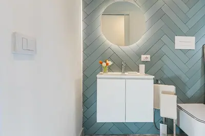 a bathroom with a sink and a mirror at GuestHost - Alle Terrazze Blu - Mondello Sea View Apartment in Palermo
