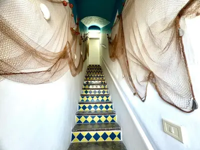 a stairway with blue and yellow tiled stairs at Casa Nonna Anna in Palermo