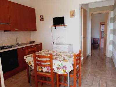a kitchen and dining room with a table and chairs at Residence Marino in Balestrate