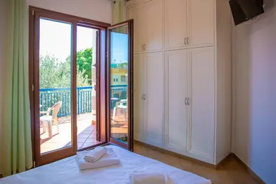 a bedroom with a bed and a balcony with a view at Solemar Sicilia - Villa Mariù in Palermo