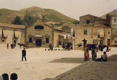 a group of people standing around in a courtyard at Affittacamere La Cartiera in Palazzo Adriano