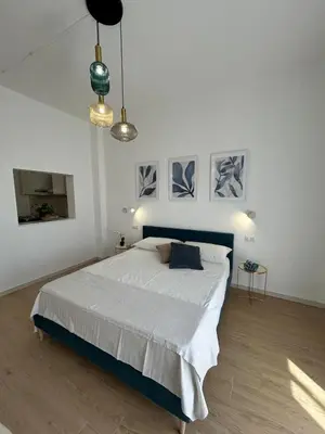 a white room with a television and a mirror at Antò 2.0 in Castellammare del Golfo