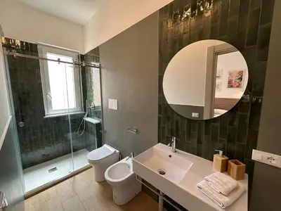 a bathroom with a shower and a toilet and a sink at Antò 2.0 in Castellammare del Golfo