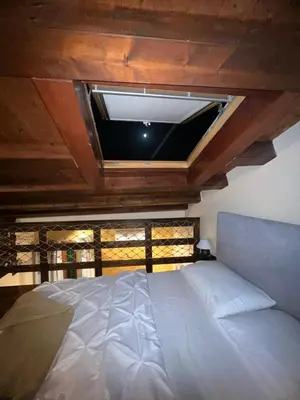a bedroom with a large bed with a window at La casetta di Giò Giò appartamento in centro a Monreale in Monreale
