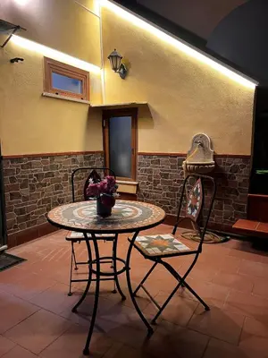 a table and two chairs in a room at La casetta di Giò Giò appartamento in centro a Monreale in Monreale