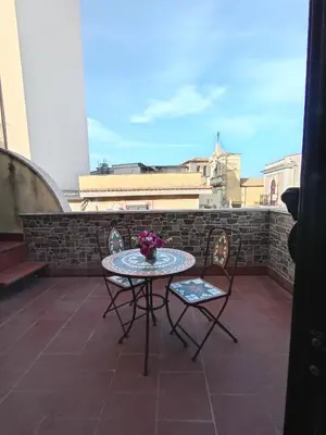 a table and two chairs on a balcony with a view at La casetta di Giò Giò appartamento in centro a Monreale in Monreale