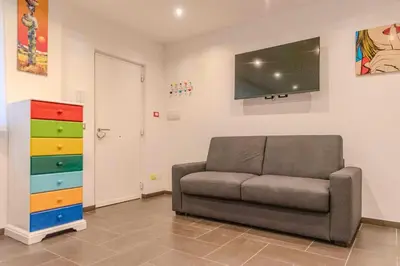 a living room with a couch and a flat screen tv at Casetta dei Colori - Apartament in Palermo