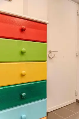 a stack of colorful drawers next to a door at Casetta dei Colori - Apartament in Palermo