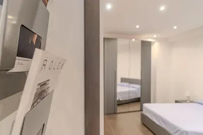 a room with a bedroom with a bed and a mirror at Casetta dei Colori - Apartament in Palermo