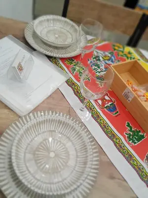 a table with plates and wine glasses on it at Al Cortile del capo in Palermo
