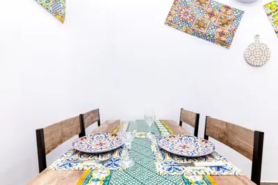 a dining room table with plates and dishes on it at Al Cortile del capo in Palermo
