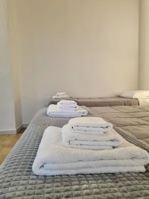 a group of towels are stacked on a bed at Downtown Maqueda in Palermo