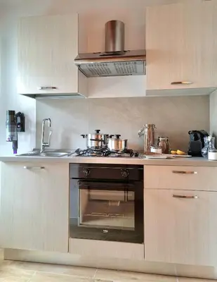 a kitchen with a stove and a sink at Downtown Maqueda in Palermo