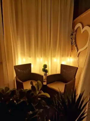 two chairs and a table with a plant in a room at Politeama Dependance in Palermo