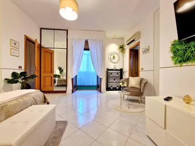 a bedroom with a bed and a living room at Politeama Dependance in Palermo