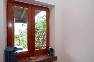 a wooden window in a white room with at Casa Za Lisa con Vista Mare a Macari in Macari