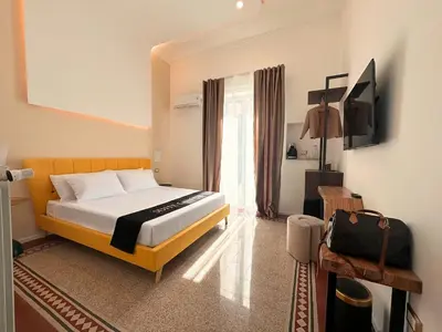 a bedroom with a bed and a television in it at Suites Cavour holiday dream in Palermo