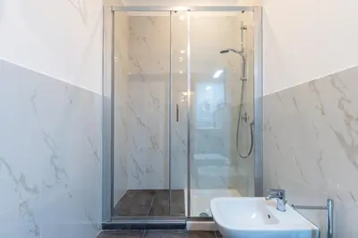 a bedroom with a large bed and two night stands at Palazzo Falcone Apartments in Palermo