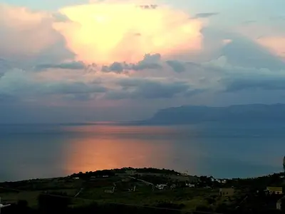 a view of the ocean under a cloudy sky at B&B Tre Giummare in Scopello