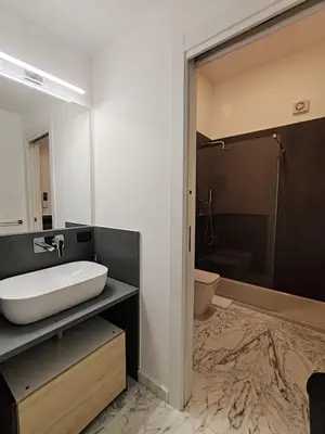 a bathroom with a sink and a shower and a toilet at Lily Apartments in Palermo