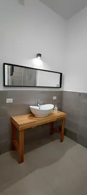 a bathroom with a sink and a mirror at Palermo Belmonte Florio in Palermo