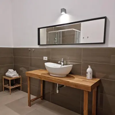 a bathroom with a sink and a mirror at Palermo Belmonte Florio in Palermo