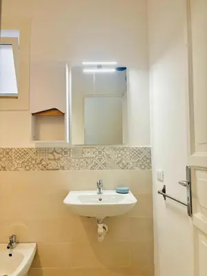 a bathroom with a sink and a mirror at Calamari37 in Palermo