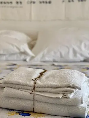 a pile of towels sitting on top of a bed at La casa di Gisa&Laura Lido di Mondello spiaggia in Palermo