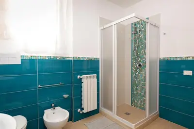 a bathroom with a shower with a toilet and a sink at Casa vacanze near airport in Cinisi