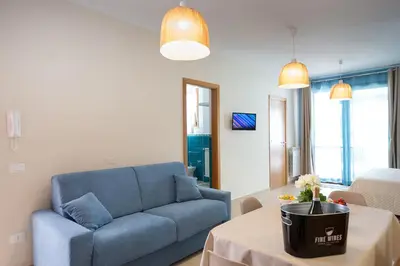 a living room with a blue couch and a table at Casa vacanze near airport in Cinisi