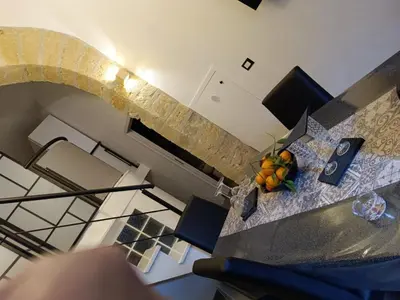 a room with a table with a bowl of fruit on it at Lannari 176 Casa vacanze Bagheria in Bagheria