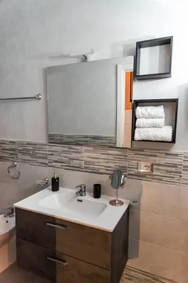 a bathroom with a sink and a mirror at Lannari 176 Casa vacanze Bagheria in Bagheria