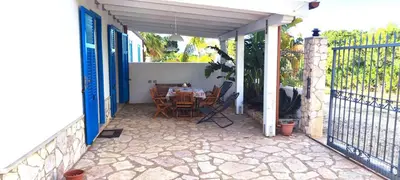 a patio with a table and chairs on a porch at Villa Indipendente Tranquillità e Relax in San Vito lo Capo