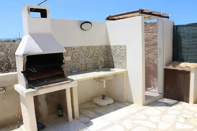 a kitchen with a wood stove in a room at Villa Indipendente Tranquillità e Relax in San Vito lo Capo