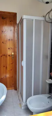 a bathroom with a shower and a toilet and a sink at Villa Indipendente Tranquillità e Relax in San Vito lo Capo