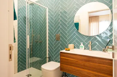 a bathroom with a toilet and a sink and a mirror at Casa Alexandra - Luxury & Design in Castellammare del Golfo