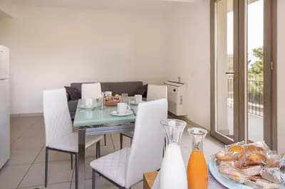 a dining room with a table with a plate of food at Capo Zafferano Apartments in Santa Flavia
