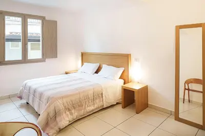 a bedroom with a large bed and a window at Capo Zafferano Apartments in Santa Flavia