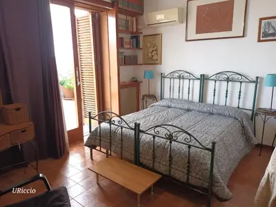 a bedroom with a bed in a room with a window at Casa Riccio in Palermo